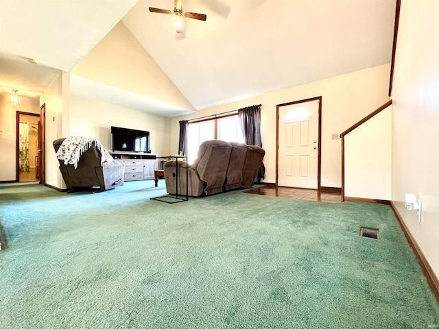 carpeted living room with ceiling fan, baseboards, and high vaulted ceiling