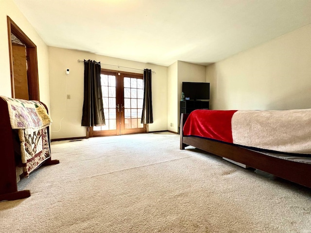 carpeted bedroom featuring french doors, baseboards, and access to exterior