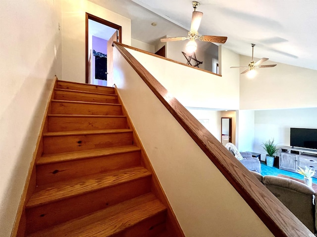 stairway featuring vaulted ceiling and a ceiling fan