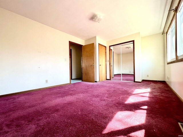 unfurnished bedroom with carpet flooring, visible vents, and baseboards