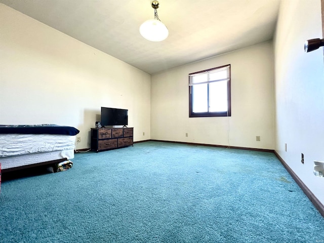 bedroom with carpet flooring, lofted ceiling, and baseboards