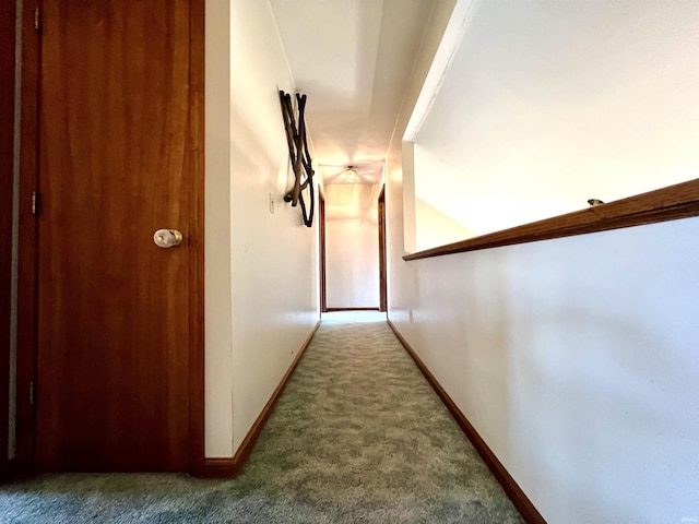 hallway with baseboards and carpet floors