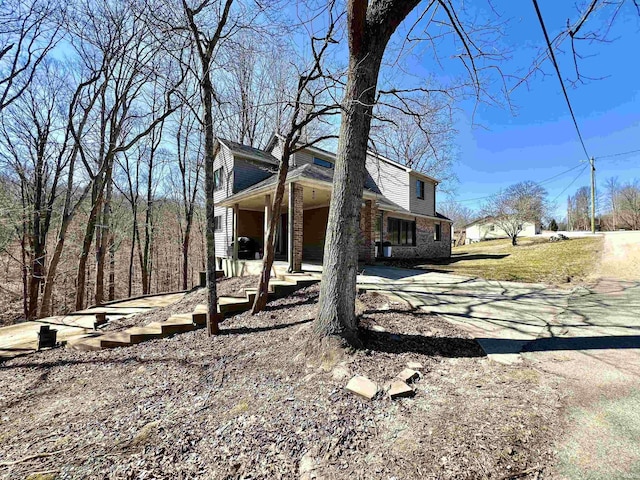 view of side of home with brick siding