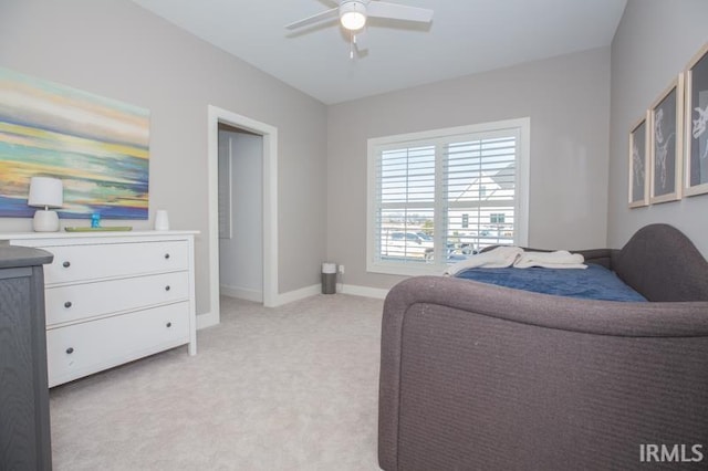 sitting room featuring light colored carpet, baseboards, and ceiling fan