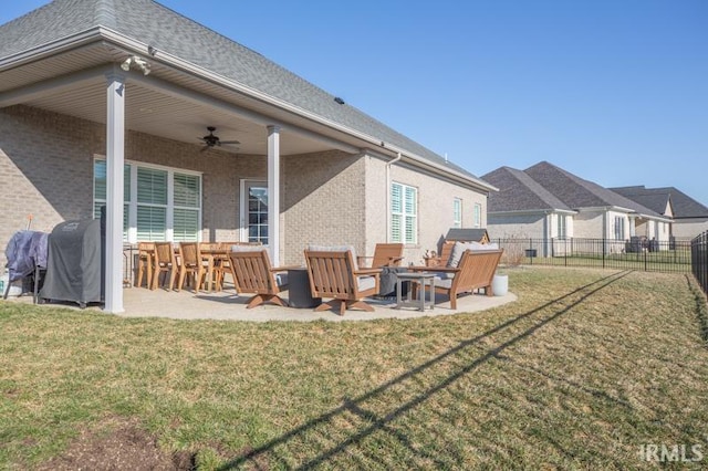 view of yard with fence, ceiling fan, an outdoor fire pit, and a patio area