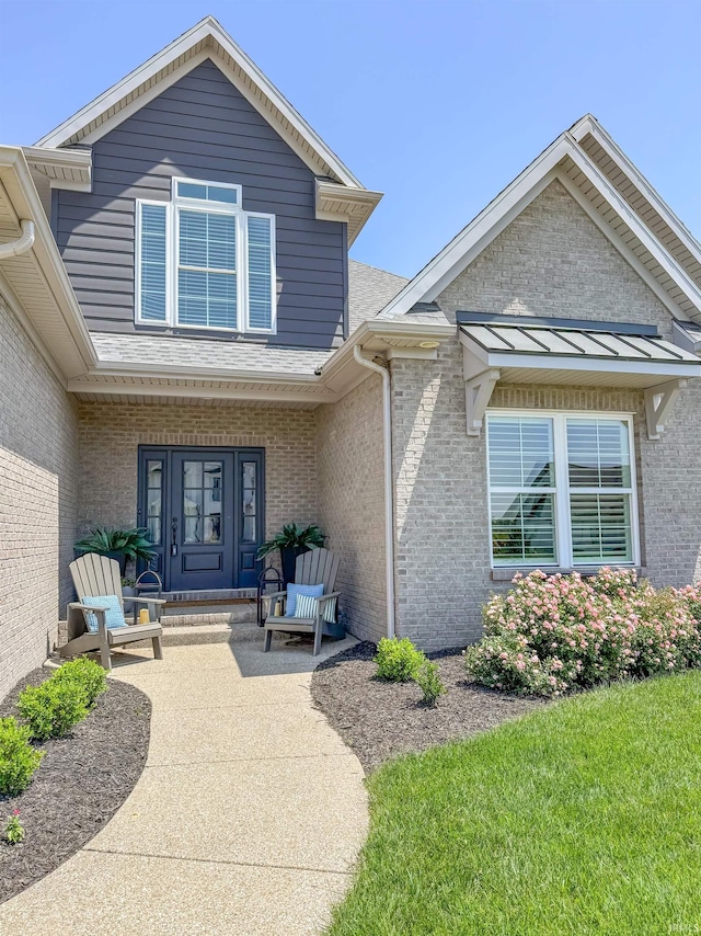 18525 Whitfield Ct, Evansville, IN 47725 - property entrance with brick siding, roof with shingles, and covered porch