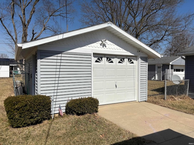 detached garage with driveway and fence