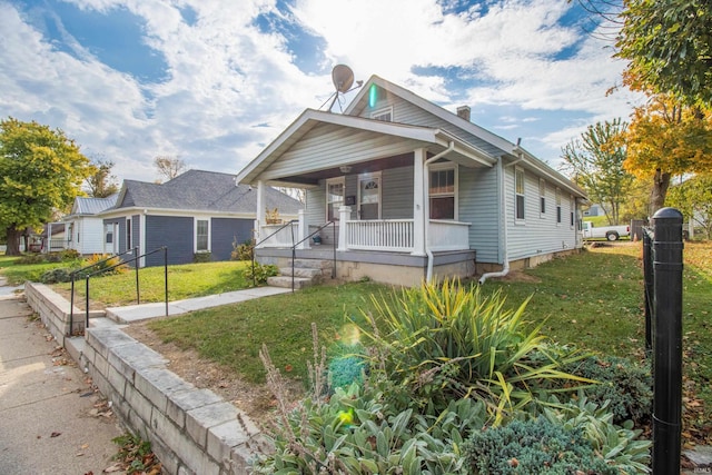 view of front of home featuring covered porch and a front yard