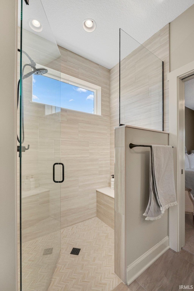 full bathroom with wood finished floors, baseboards, ensuite bath, recessed lighting, and a tile shower