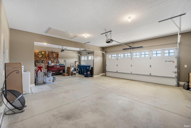 garage featuring washer / clothes dryer and a garage door opener