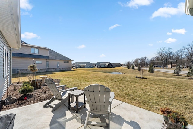 view of patio / terrace featuring central air condition unit and a water view