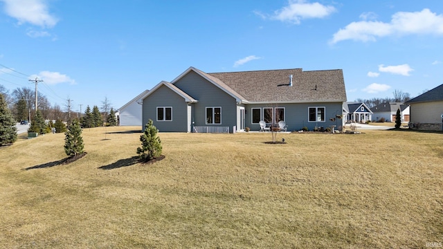 rear view of house featuring a yard