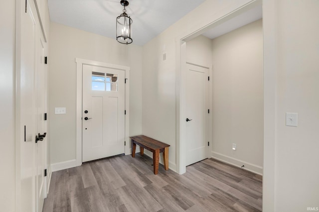 entryway featuring light wood-type flooring and baseboards