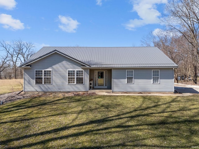 single story home with a front yard and metal roof