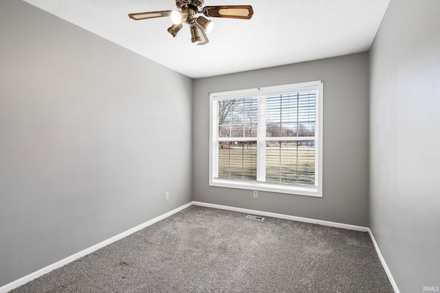 empty room with visible vents, baseboards, ceiling fan, and carpet flooring