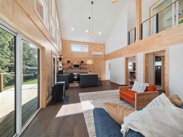 living area with recessed lighting, dark wood-style flooring, wood walls, and high vaulted ceiling