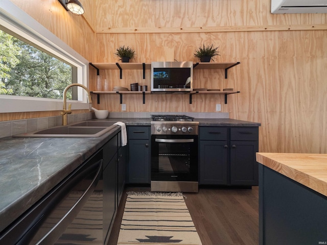 kitchen featuring a sink, open shelves, appliances with stainless steel finishes, and a wall mounted AC