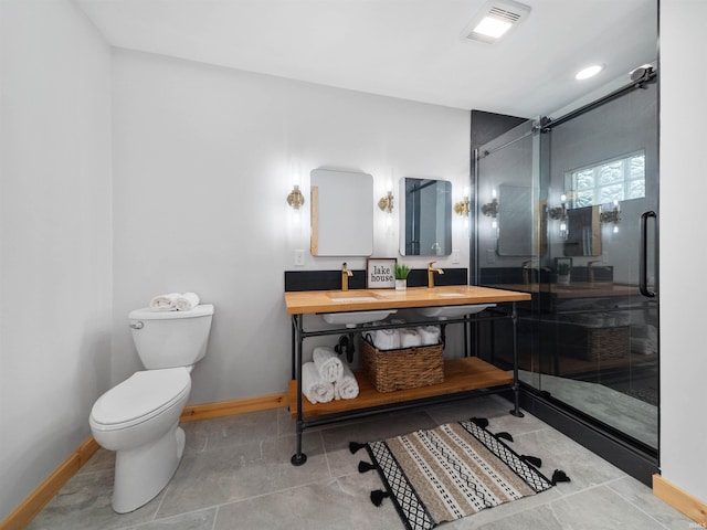 full bath with visible vents, a shower stall, baseboards, toilet, and a sink