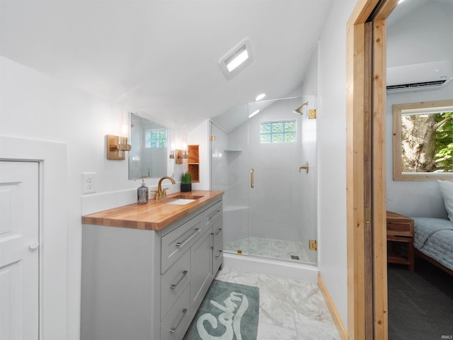 full bath featuring marble finish floor, a stall shower, vanity, and vaulted ceiling