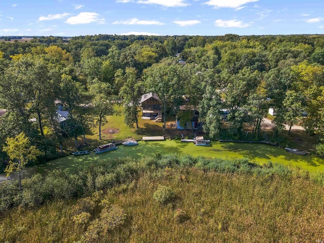 birds eye view of property with a view of trees