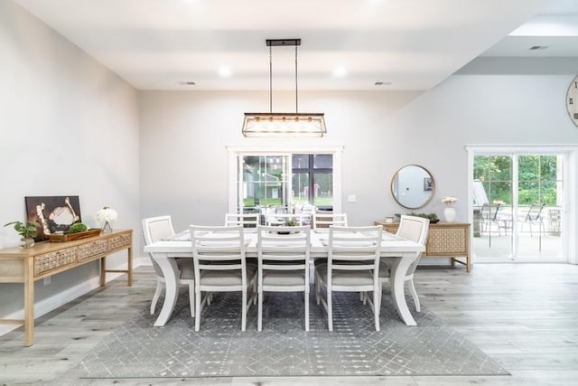 dining space with recessed lighting, baseboards, and light wood finished floors