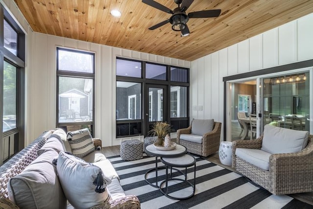 living room featuring wooden ceiling, plenty of natural light, a ceiling fan, and wood finished floors