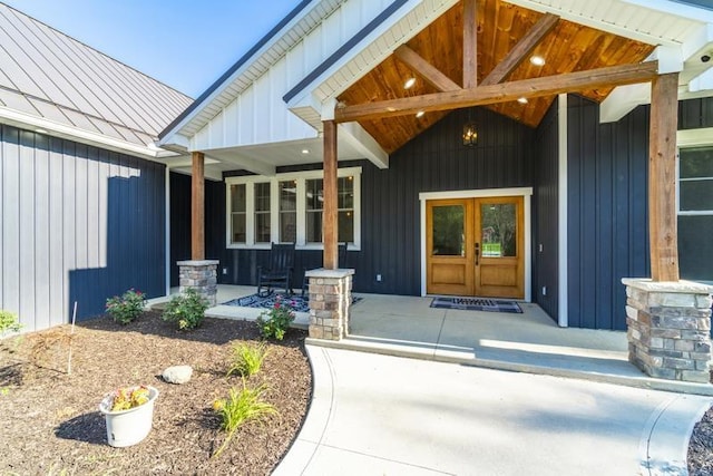 entrance to property featuring a porch, board and batten siding, metal roof, and a standing seam roof