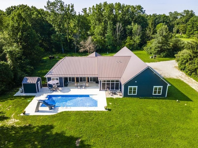 outdoor pool with a yard, an outdoor structure, and a patio