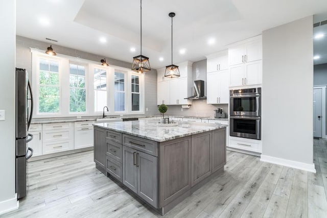 kitchen with stainless steel appliances, tasteful backsplash, white cabinets, and gray cabinets