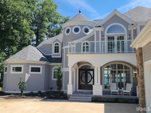 view of front of house featuring french doors and a balcony