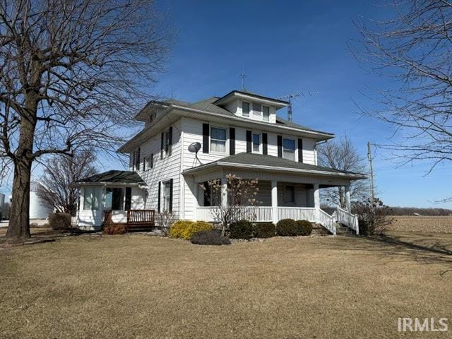 view of front of home featuring covered porch and a front lawn