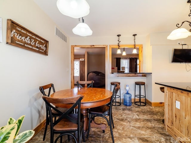 dining room with visible vents and baseboards