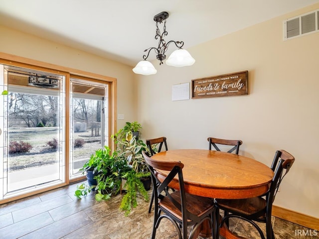 dining room featuring baseboards and visible vents