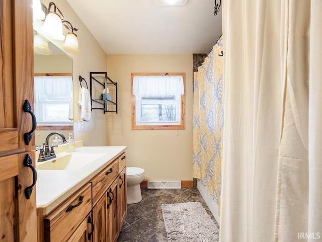 full bath featuring a wealth of natural light, visible vents, toilet, and vanity