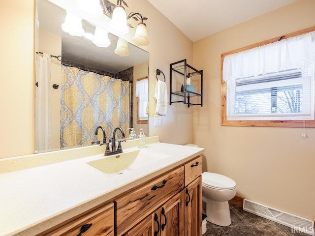 bathroom featuring vanity, toilet, baseboards, and visible vents