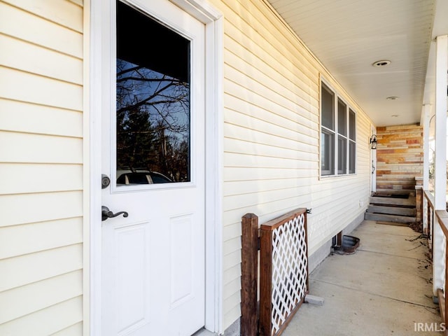 view of exterior entry with a porch