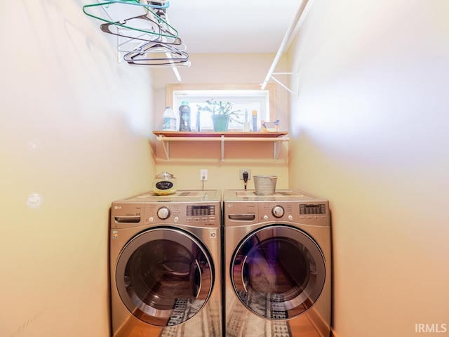 clothes washing area featuring laundry area and washer and clothes dryer