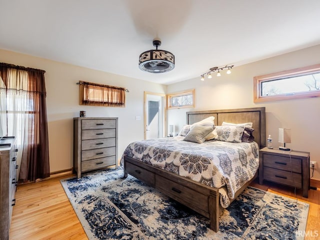 bedroom with baseboards and light wood-type flooring