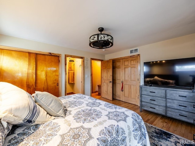 bedroom with wood finished floors and visible vents