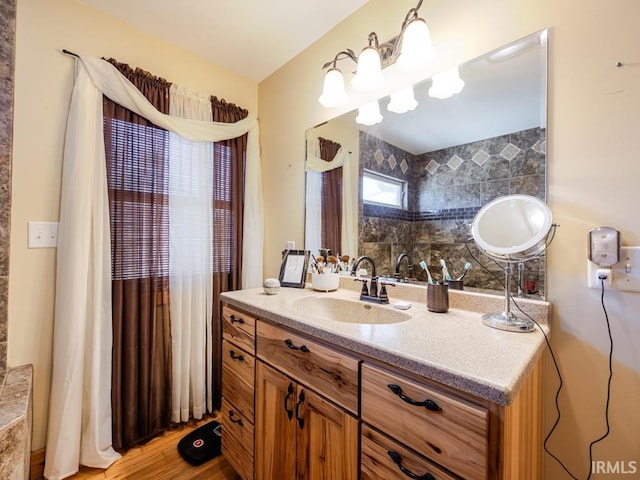 bathroom with wood finished floors and vanity