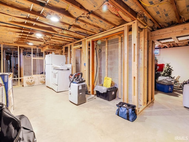 unfinished below grade area with separate washer and dryer and freestanding refrigerator