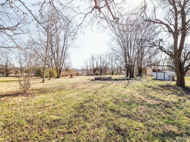 view of yard featuring a storage shed and an outbuilding