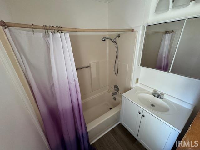 full bathroom with vanity, wood finished floors, and shower / bath combo with shower curtain