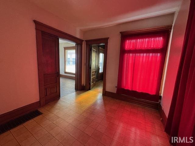 empty room with visible vents and baseboards