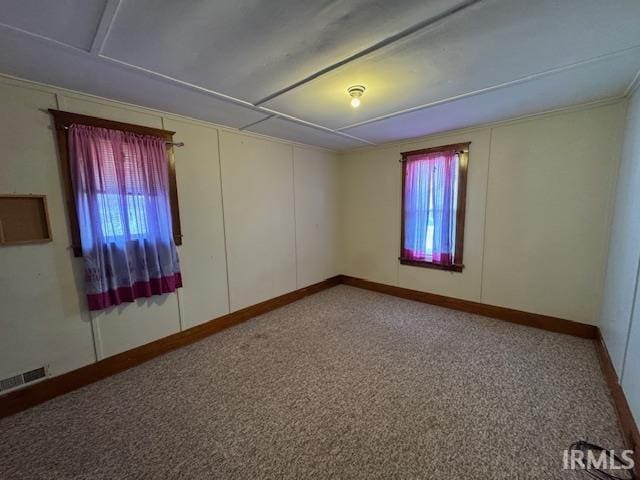 empty room featuring visible vents and baseboards