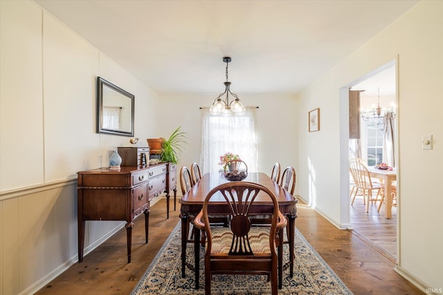 dining area with a notable chandelier and wood finished floors