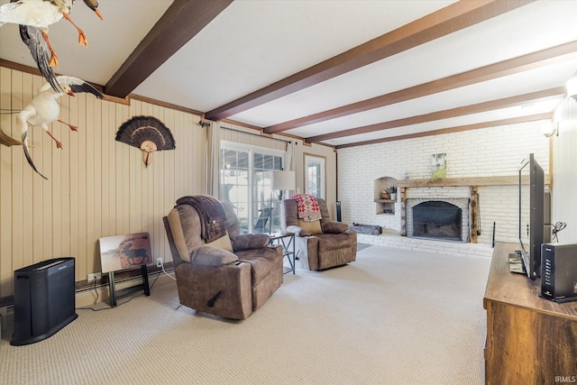 carpeted living room with beamed ceiling and a fireplace