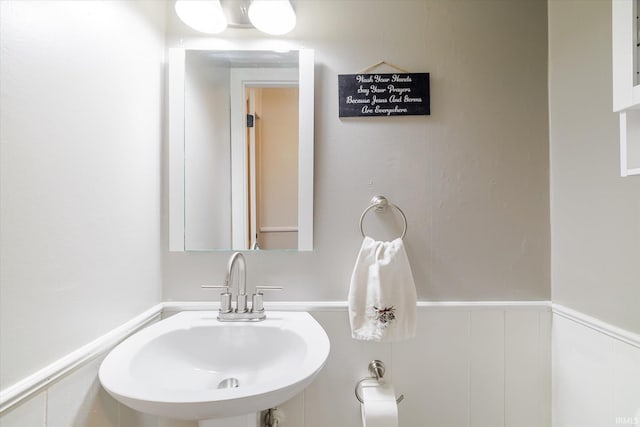 bathroom featuring wainscoting and a sink