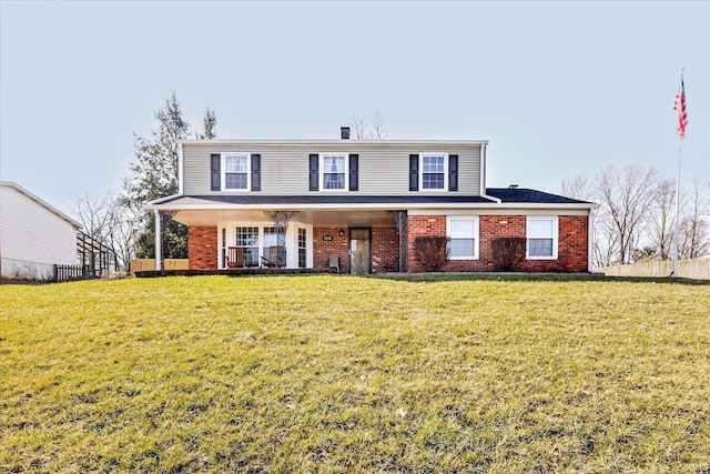 traditional home with brick siding and a front yard