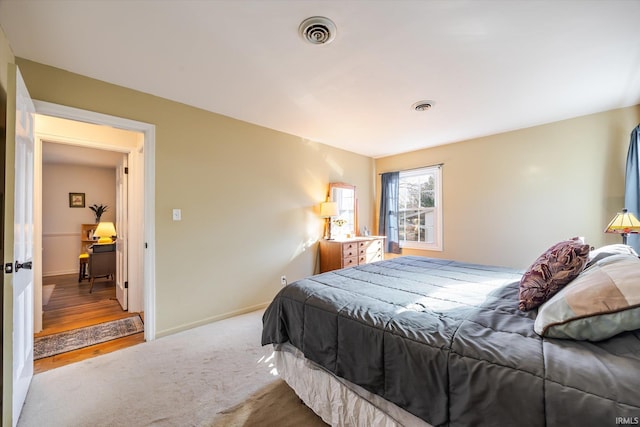 bedroom with visible vents, baseboards, and carpet flooring